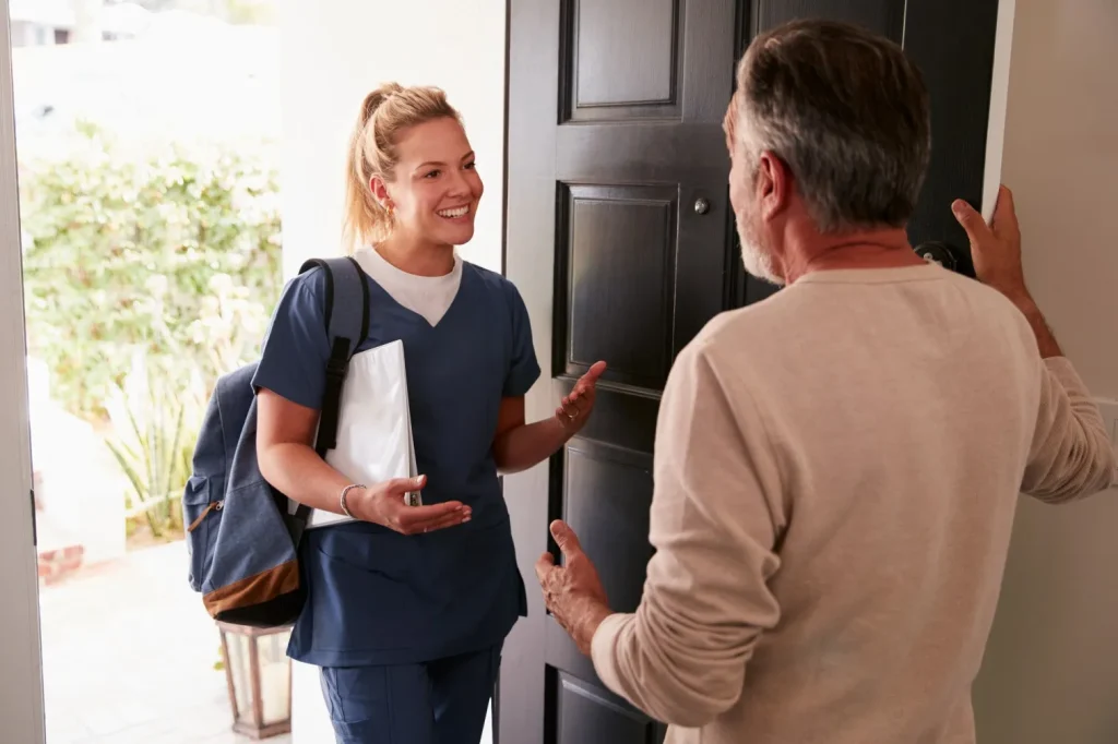 Nurse arriving at front door and greeted by man