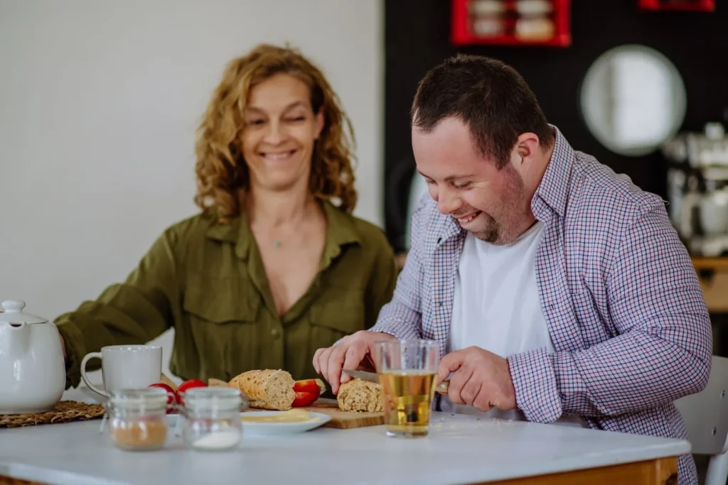 Disabled man making lunch with support worker
