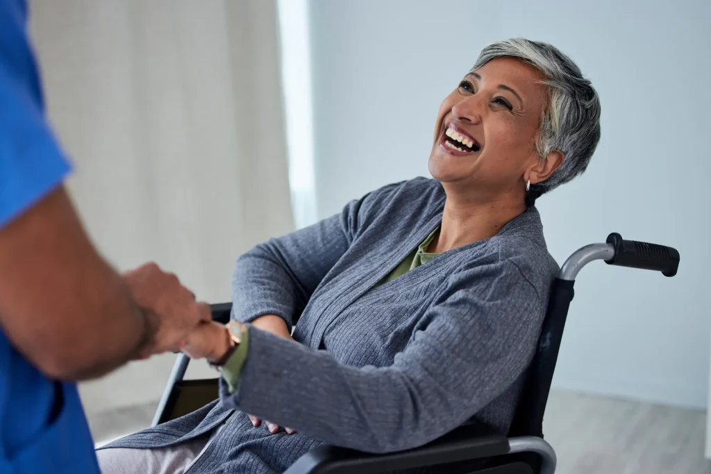 Disabled woman smiling looking at nurse
