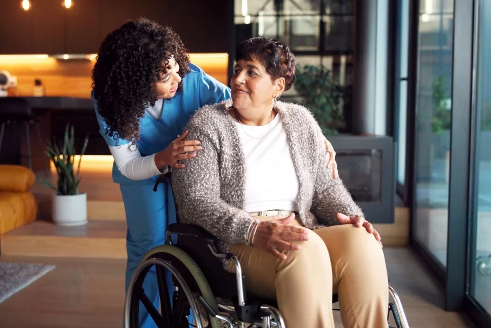 Nurse talking with disabled woman in wheelchair