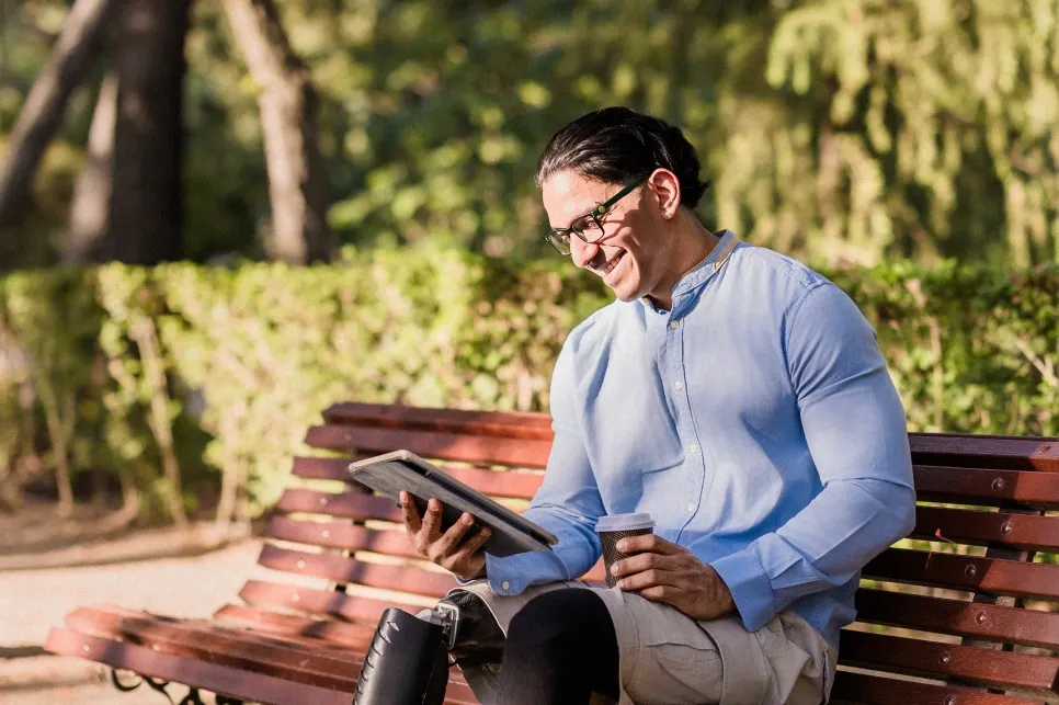 Disabled man looking at tablet